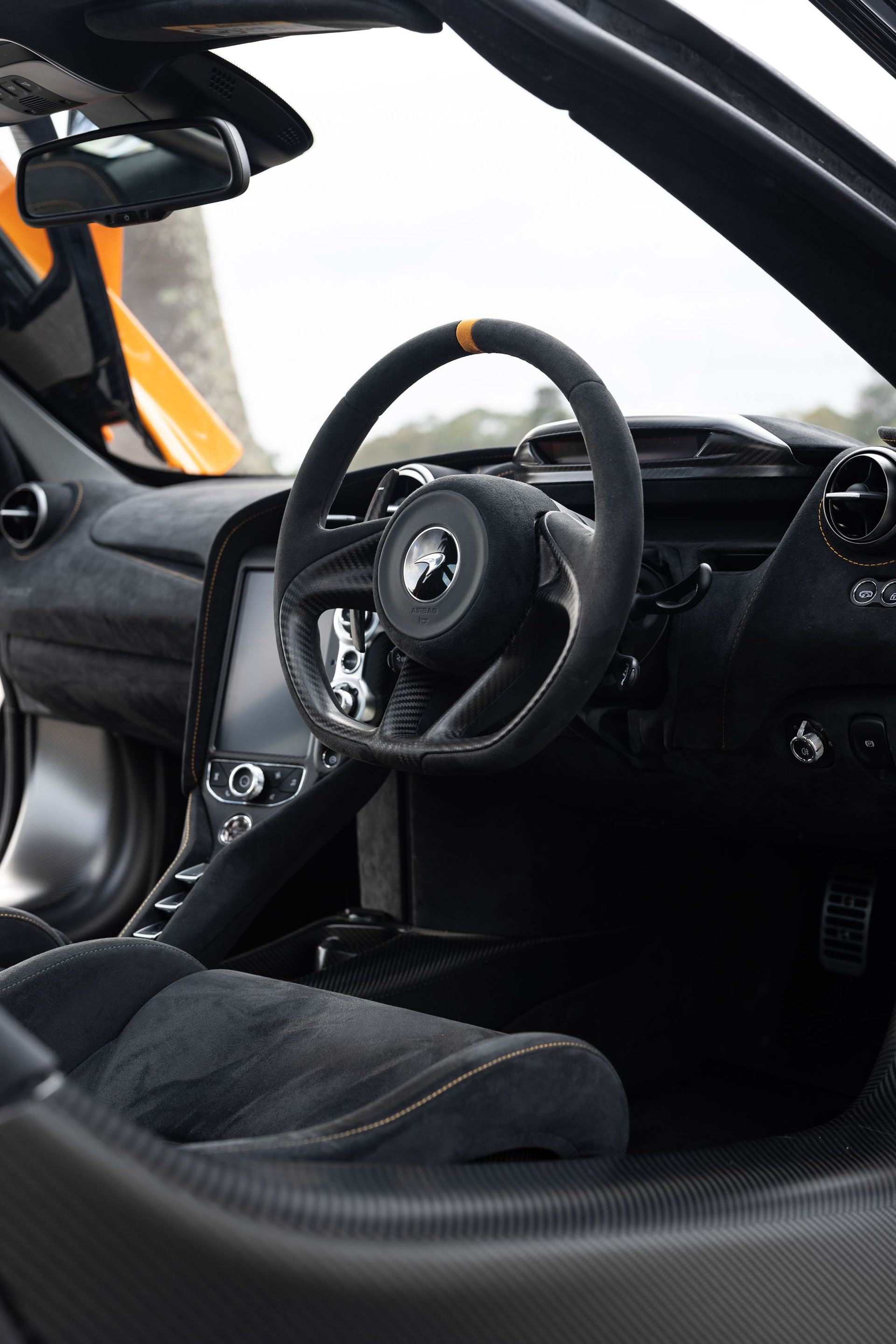 Explore a close-up view of the luxurious McLaren 765LT car interior, showcasing sleek design and premium materials.